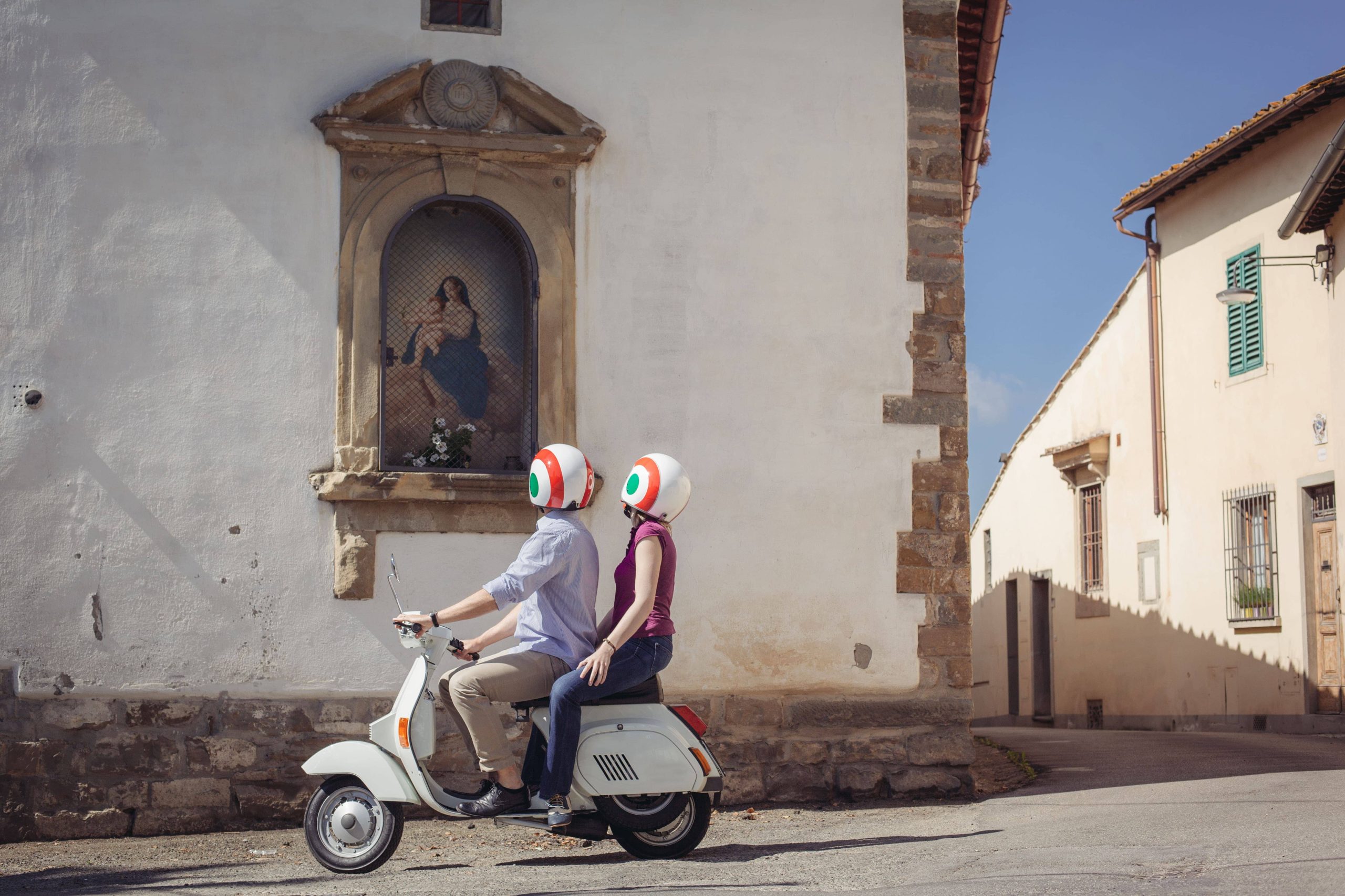 DKFPMT Couple looking at church painting from moped, Florence, Italy